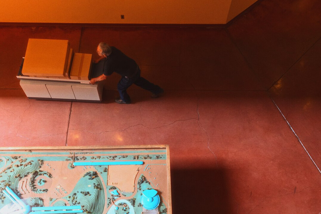 Overhead view of a producer working at a desk with laptop and notes