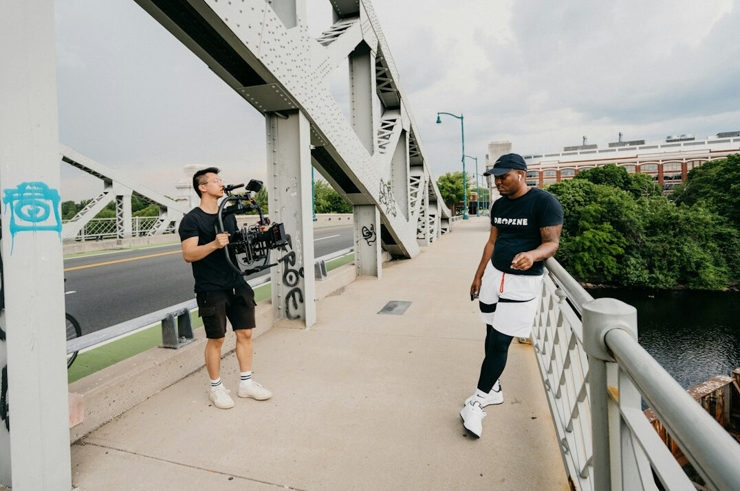 Coach and journalist reviewing recorded footage together on a monitor